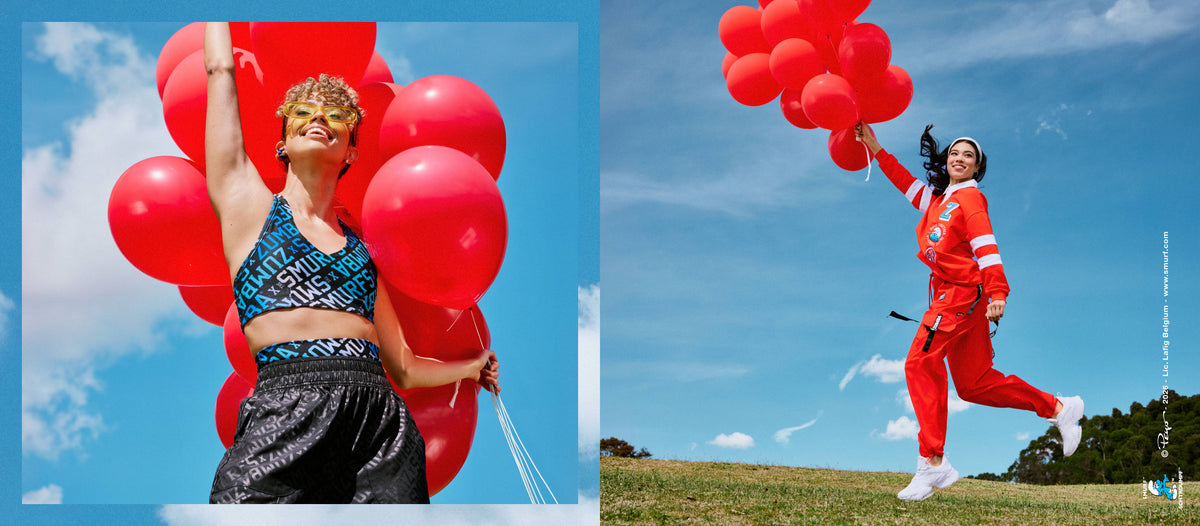 Two side-by-side photos against a blue sky. On the left, inside a blue border, a female model holds a cluster of red balloons in a blue and white 'ZUMBA' X 'THE SMURFS' print bra and black tonal print pants. On the right, a female model runs across a grassy hill holding red balloons, dressed in a red rugby polo and red cargo pants. A small Smurfs copyright credit runs along the right edge.