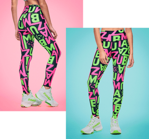 Banner showing a female model wearing black leggings covered in oversized neon green and pink “ZUMBA” lettering, paired with white and green shoes posed against split pink and aqua backdrops.