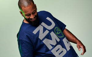 Banner of a close-up shot of a male model wearing a blue “Zumba” T-shirt, set against a light green background.