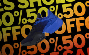 A single black and blue Zumba shoe floating against a black background with a bold yellow-to-red gradient 'SHOES' and 50% off.