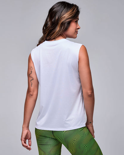 Back view of the white 'STRONG' mesh muscle tank on a female model, showing a plain back and relaxed fit, with wavy check print biker shorts.