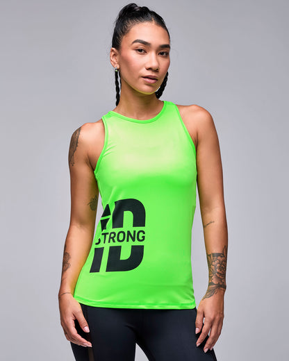 Female model in a neon green fitted high neck tank with a large black 'STRONG iD' logo at the lower right front, paired with black leggings.
