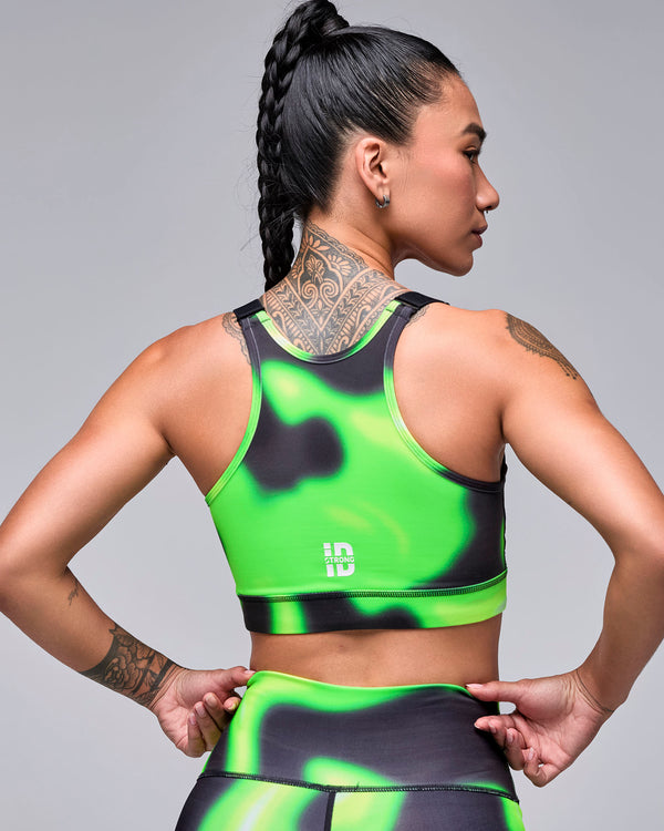 Shown from the back, the neon green and black swirl print bra with a racerback and a small white 'STRONG iD' logo near the band.