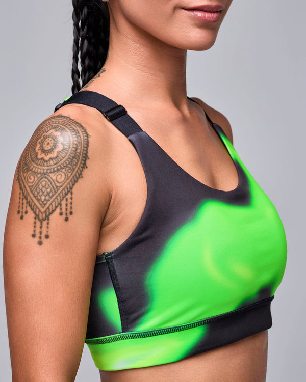 Close-up of the swirl print bra in side view, showing the black adjustable strap and smooth scoop neckline.