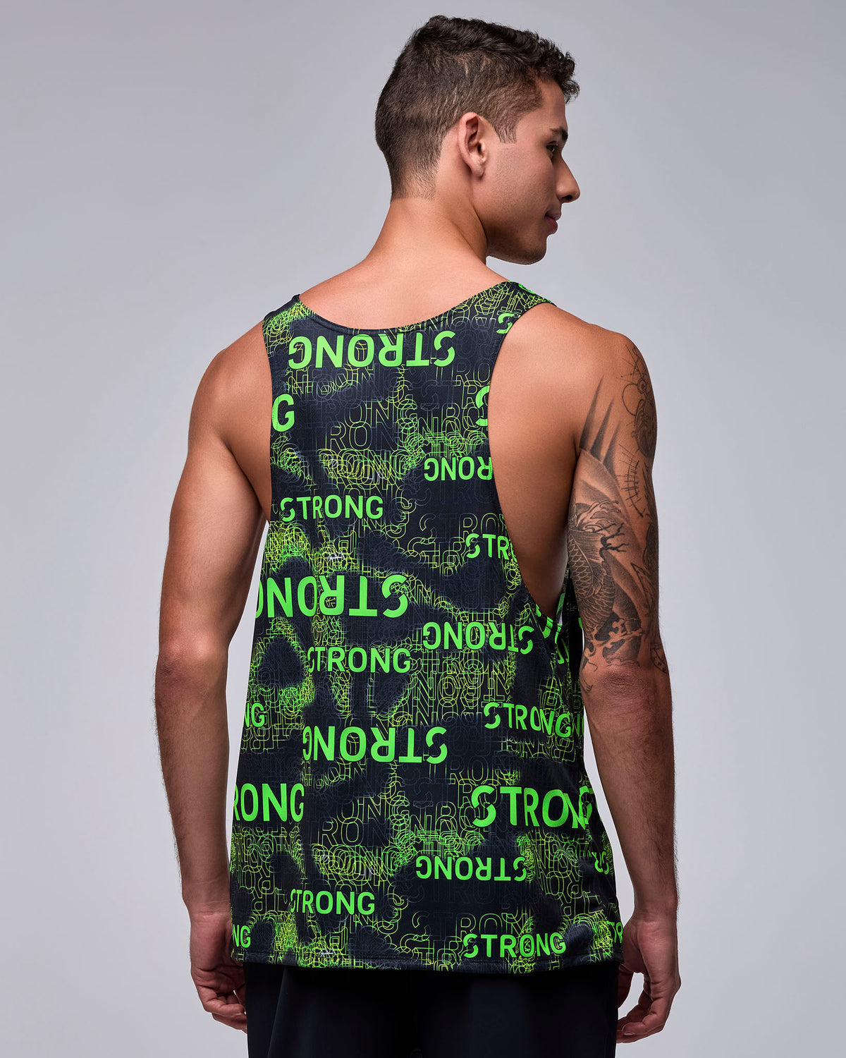 Back view of the men's 'STRONG' print drop armhole tank, showing the deep armholes and the all-over neon green text across the back.
