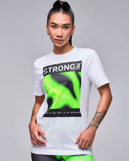 Female model in the white crew neck tee with the rectangular 'STRONG iD' graphic and neon green and black swirl panel, worn loose with neon green and black swirl print leggings.
