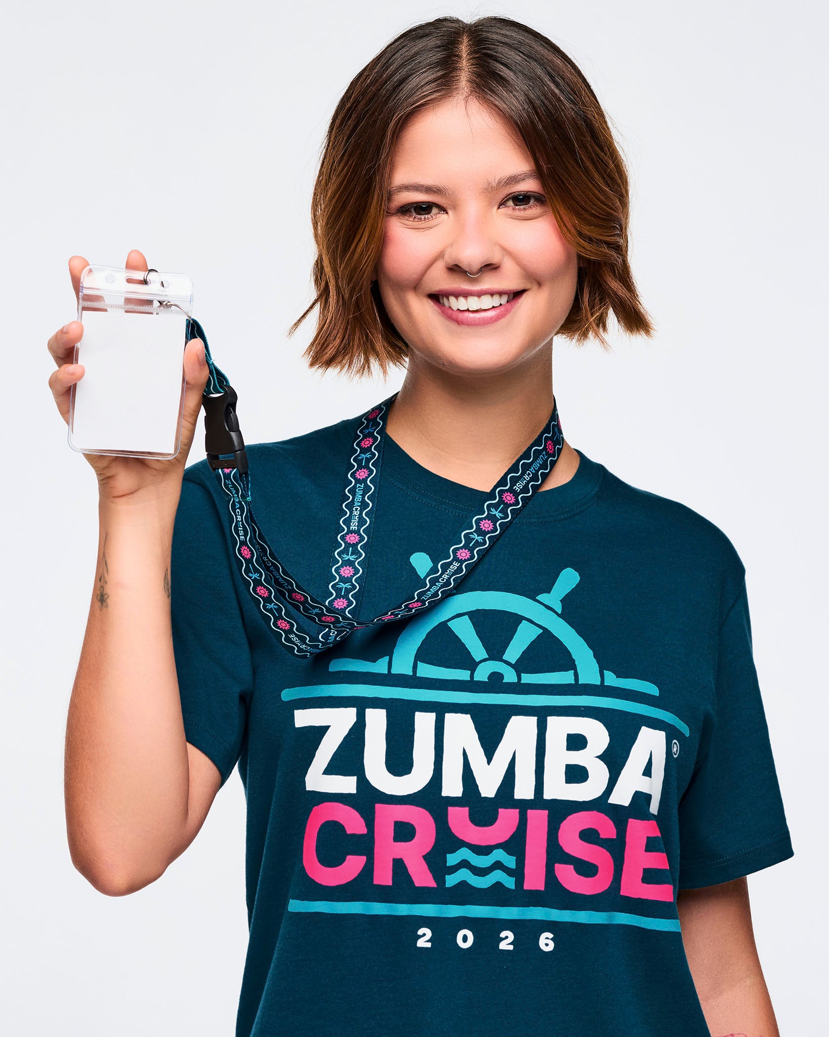 Female model wearing a blue t-shirt holding a lanyard against a plain background.
