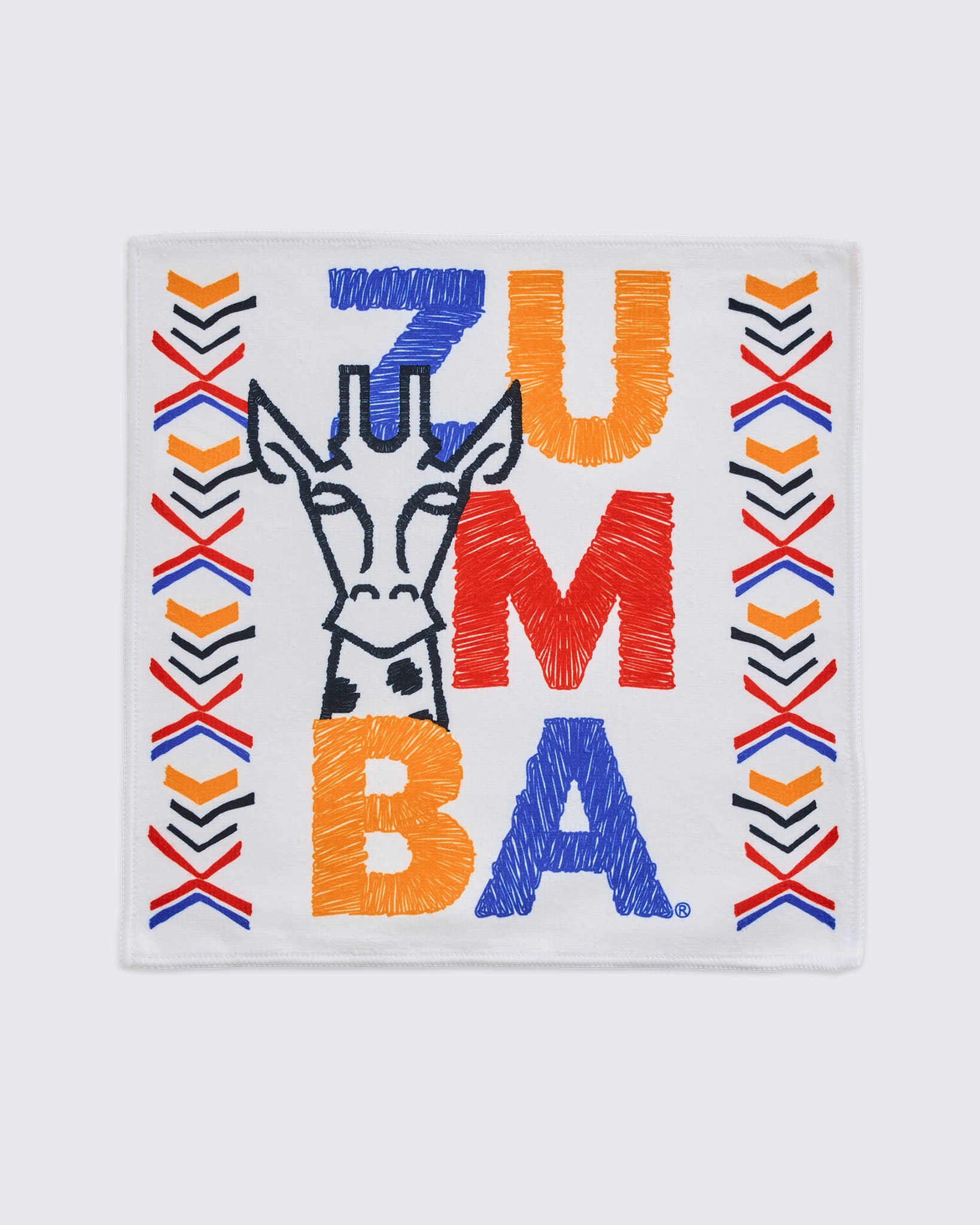 White square towel with a black embroidered giraffe outline, bold multicolor ZUMBA lettering, and red, orange, blue, and black chevron accents along both sides.