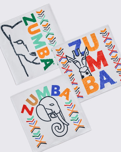 Set of three white square Zumba towels featuring embroidered animal outlines, multicolor ZUMBA lettering, and bright chevron accents; designs include a lion, elephant, and giraffe.