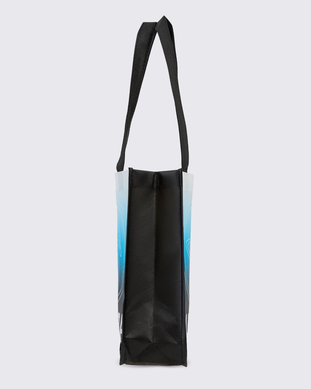 Side view of the black reusable tote with the white-to-blue gradient front, showing the solid black side gusset and a black woven handle looped above.