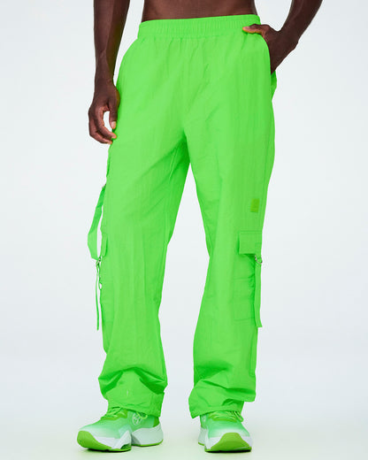 Male model in the neon green cargo pants with tassels, showing the cargo pocket and long tassel hanging along the right leg.