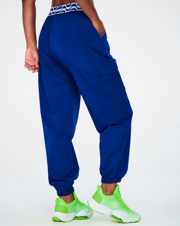 Shown from the back, the blue parachute cargo pants, with a side cargo pocket on the right leg and elastic cuffs gathered at the ankle.