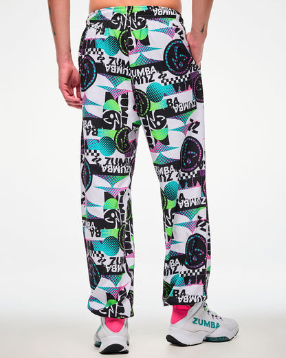 Back view of a male model wearing white track pants with an all-over abstract print, paired with white sneakers.