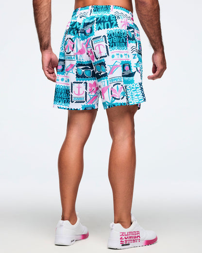 Back view of white drawstring shorts with a teal-and-pink allover Zumba tropical print; shown on a male model with white sneakers.