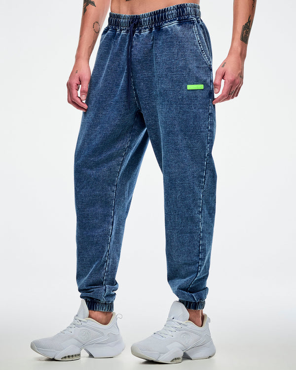 Male model wearing blue pants with a green 