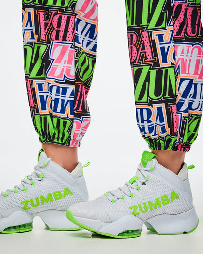 Close-up of encased elastic cuffs on multi-colored Zumba pants, paired with green-and-white shoes.