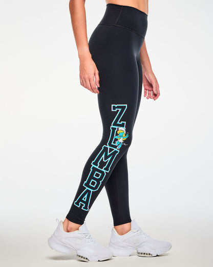 Female model in the black leggings seen from the side, with the full vertical 'ZUMBA' lettering down the right leg and Smurfette tucked beside the letter U.