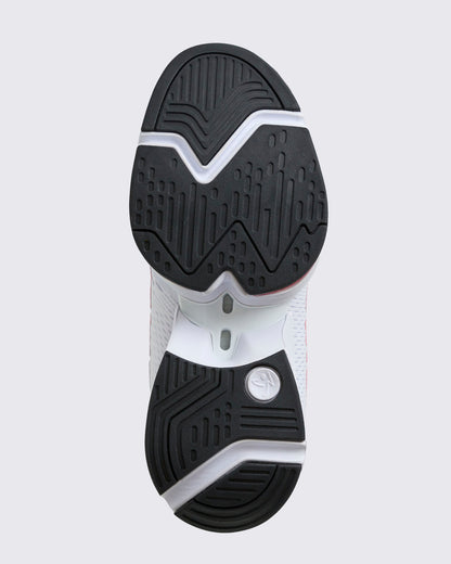 Close-up of the black rubber outsole with textured tread pattern and white midsole cutouts, shown on a light gray background.