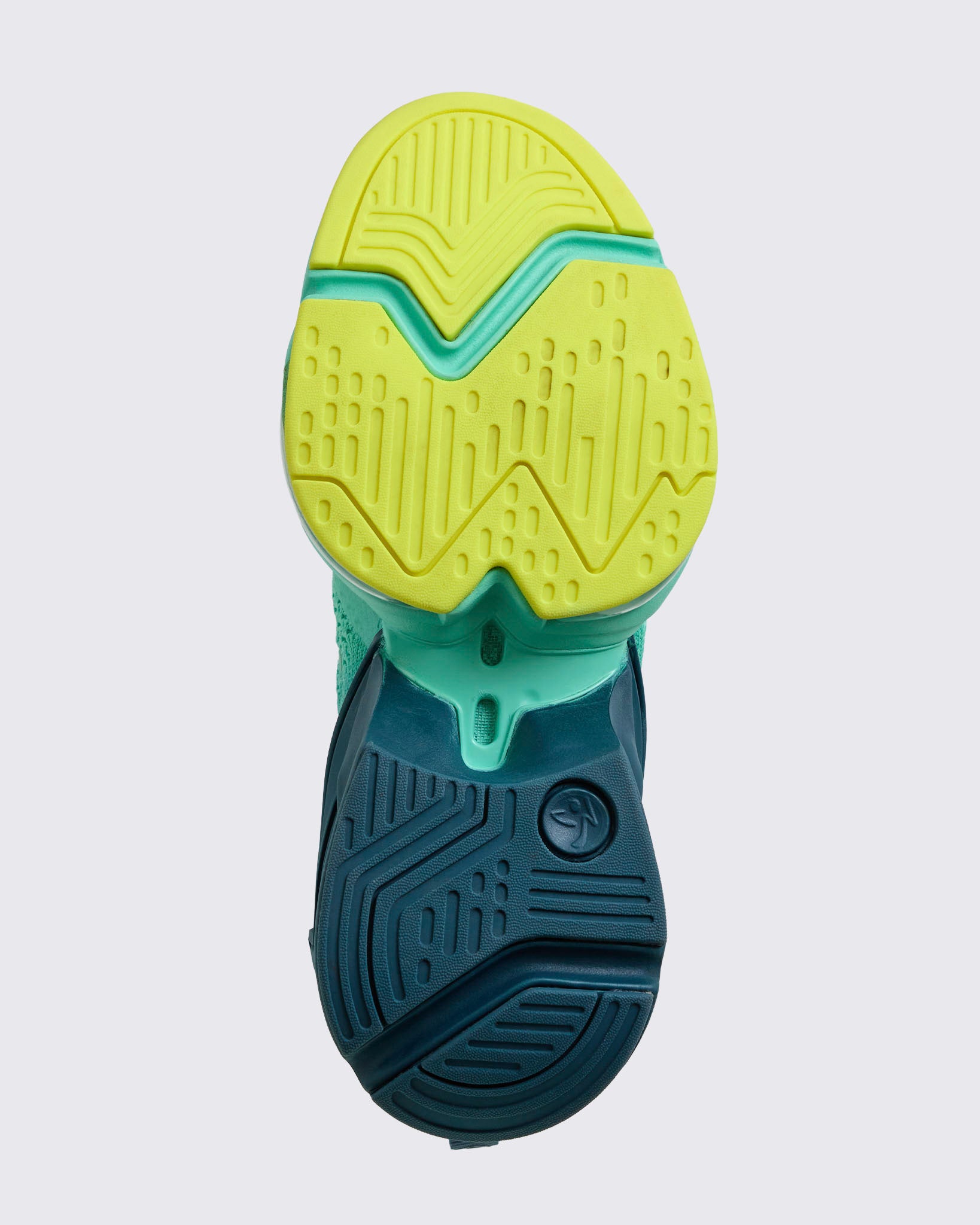 Bottom-up view of the outsole showing yellow forefoot tread, teal midfoot bridge, and navy heel traction pattern, on a light gray background.
