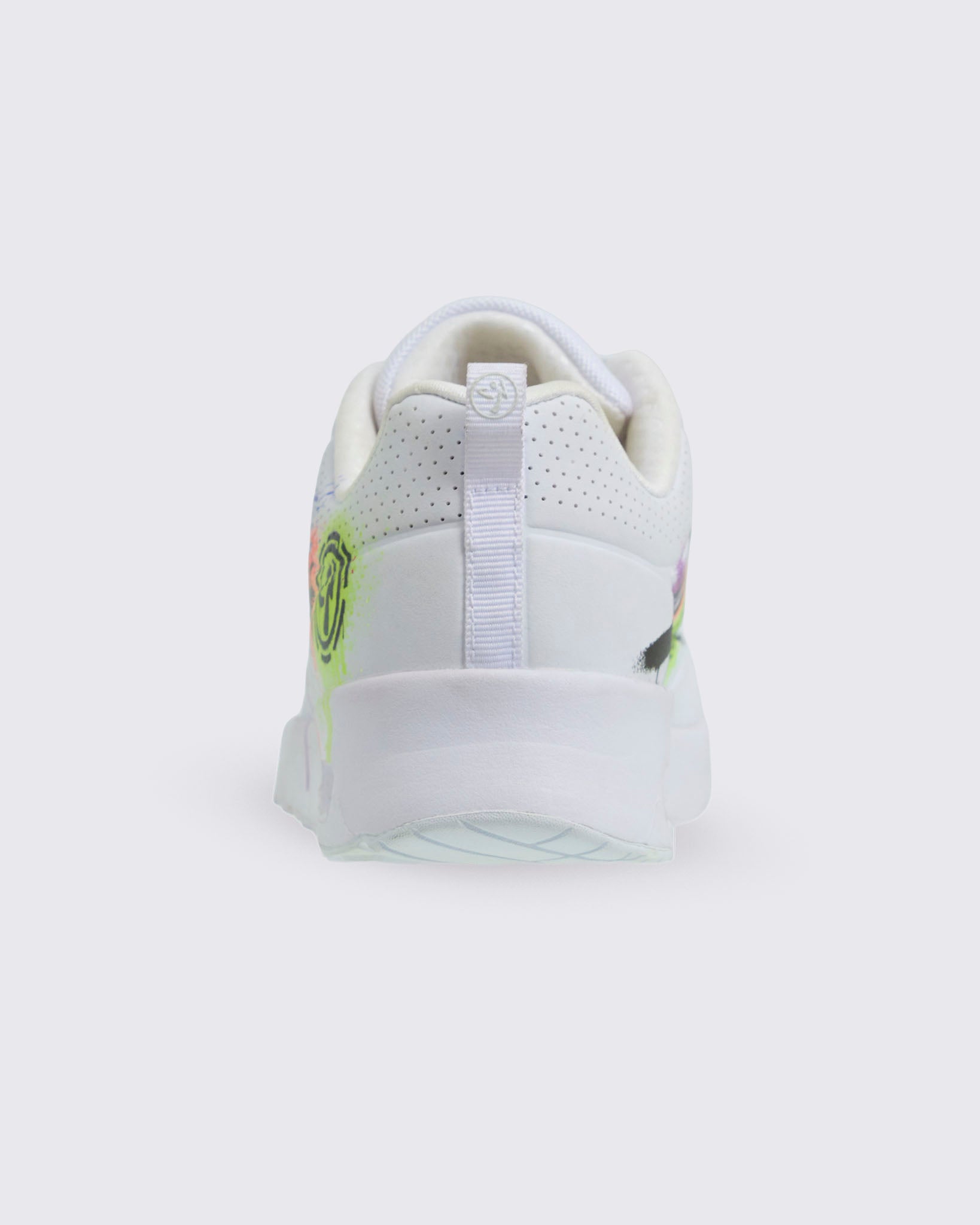 Back view of white Zumba sneaker showing white fabric heel loop against a white background.