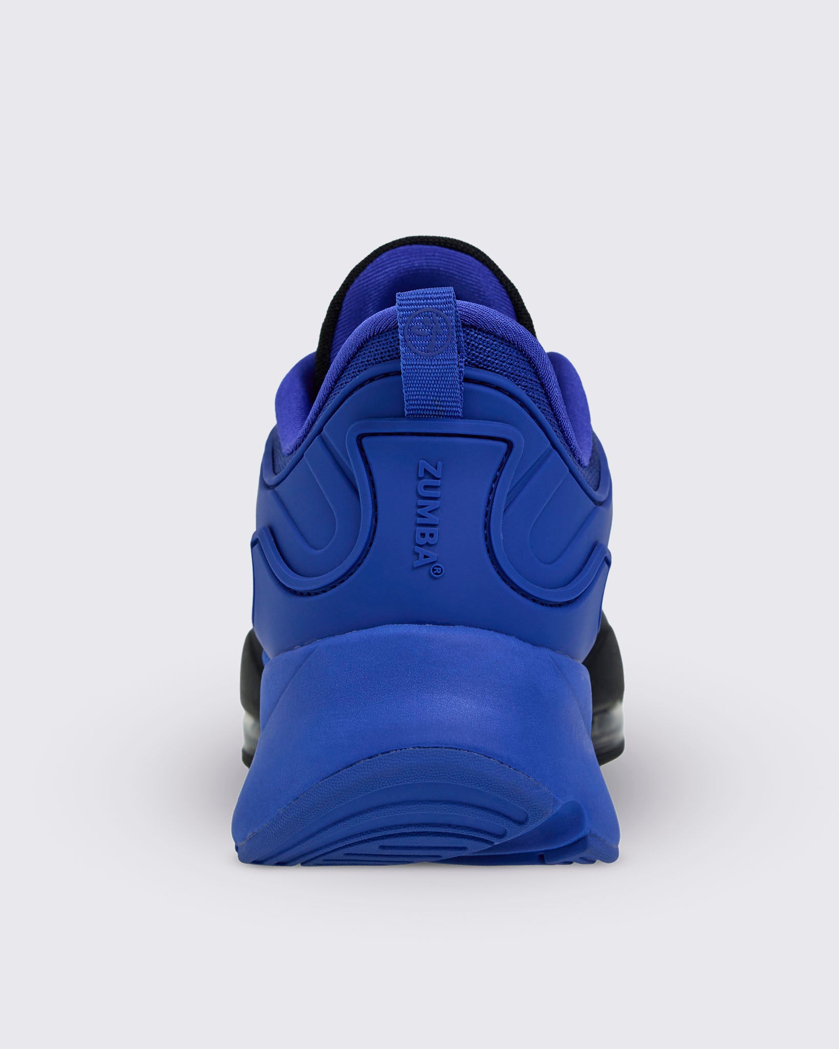 Rear view of blue Zumba sneaker with heel pull loop and embossed vertical "ZUMBA" branding in blue.