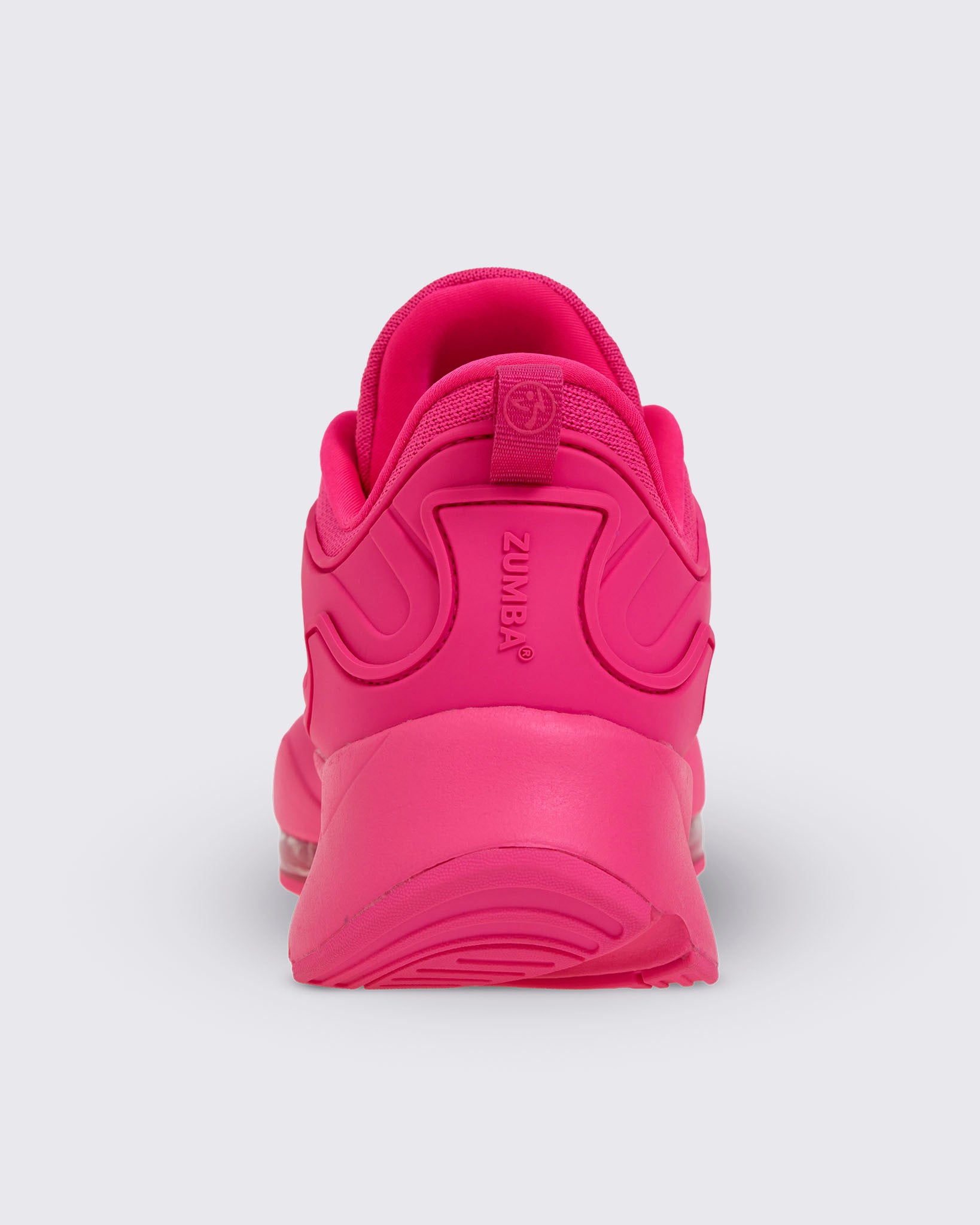 Back view of a pink Zumba shoe with Zumba in pink vertical raised text below the pink Zumba pull tab with a light pink Zumbito.