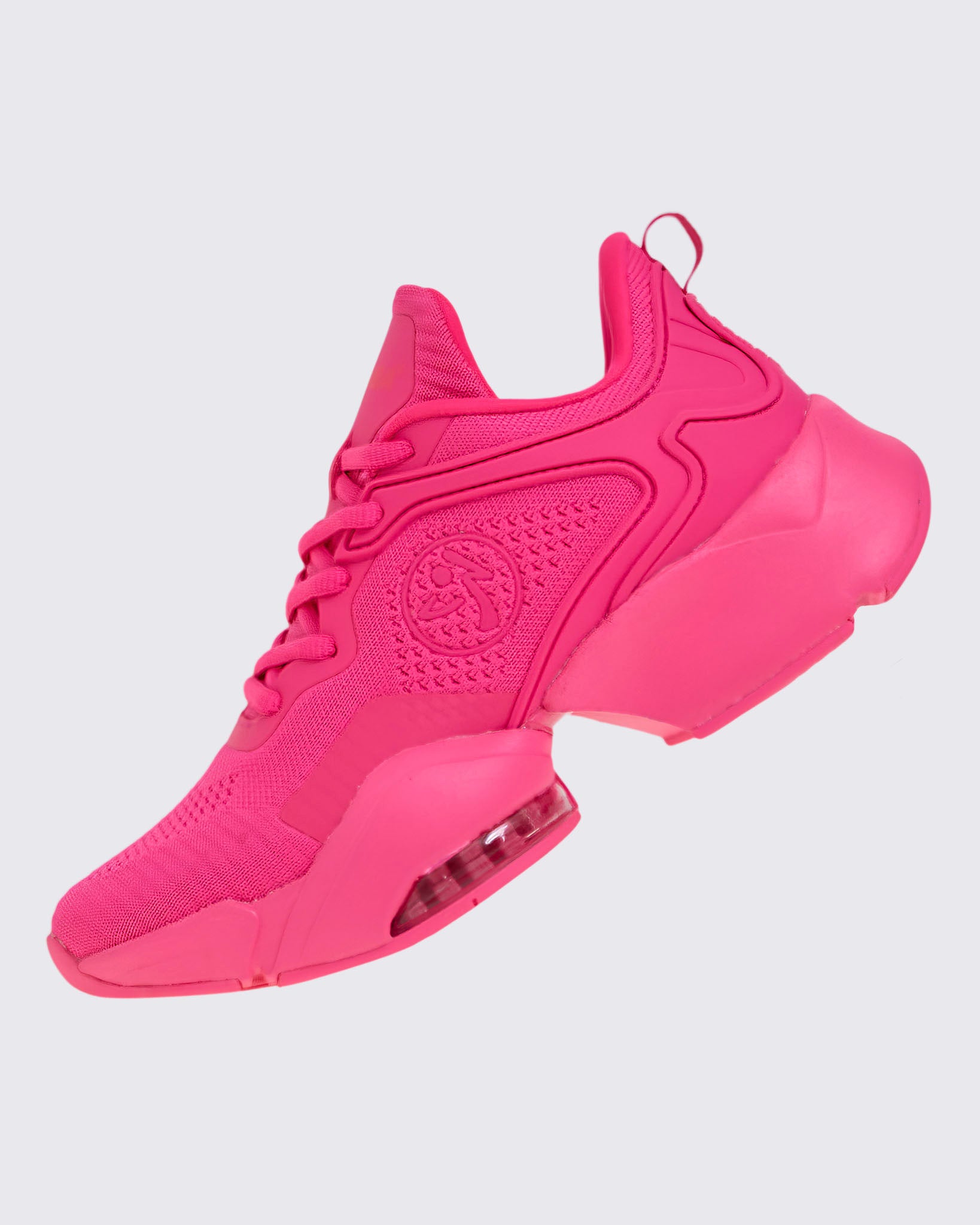 Left angled view of a pink shoe with a pink Zumbito on a white background.