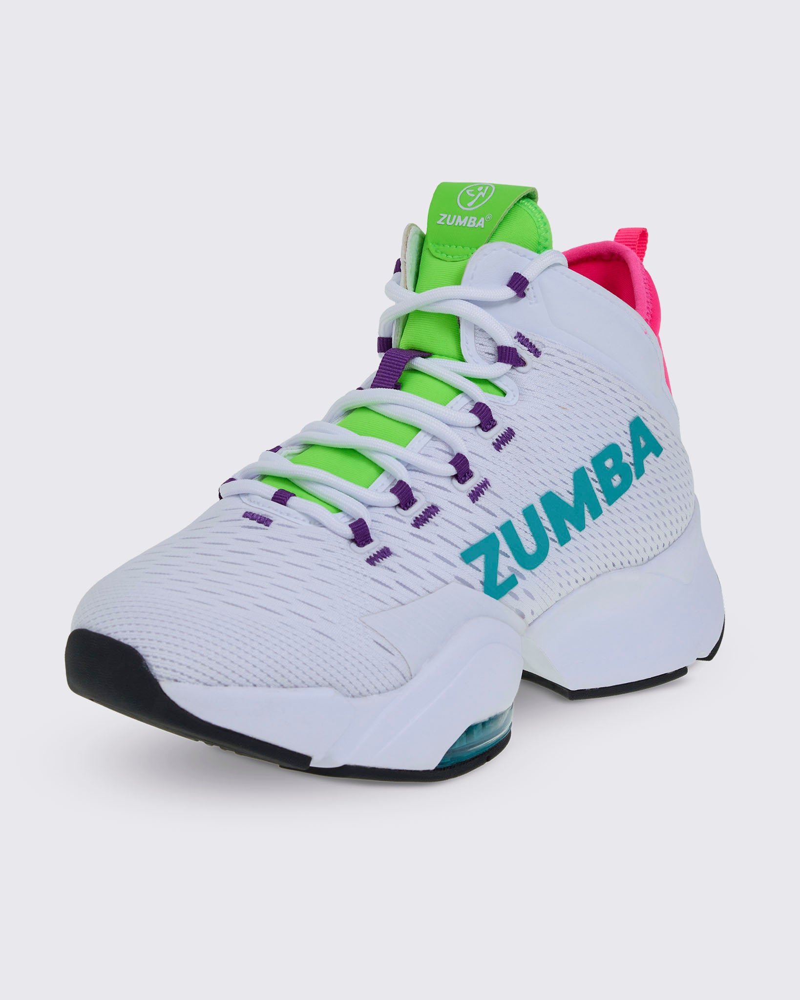 Front side view of a white Zumba sneaker with green and purple accents and aqua "ZUMBA" text on the side, against a white background.