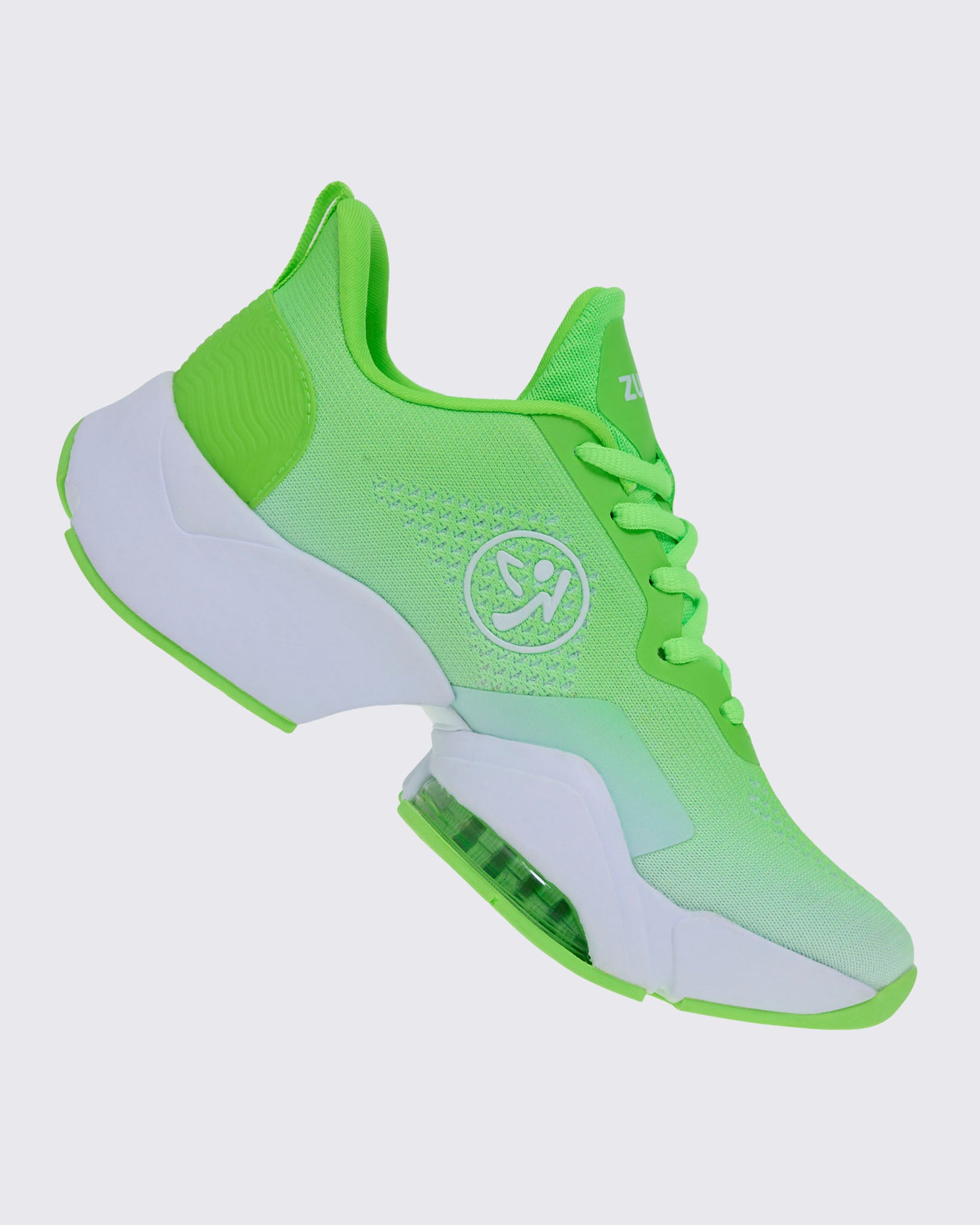 Right side view of a neon green sneaker tilted forward, showing a white Zumbito logo and white midsole panel.
