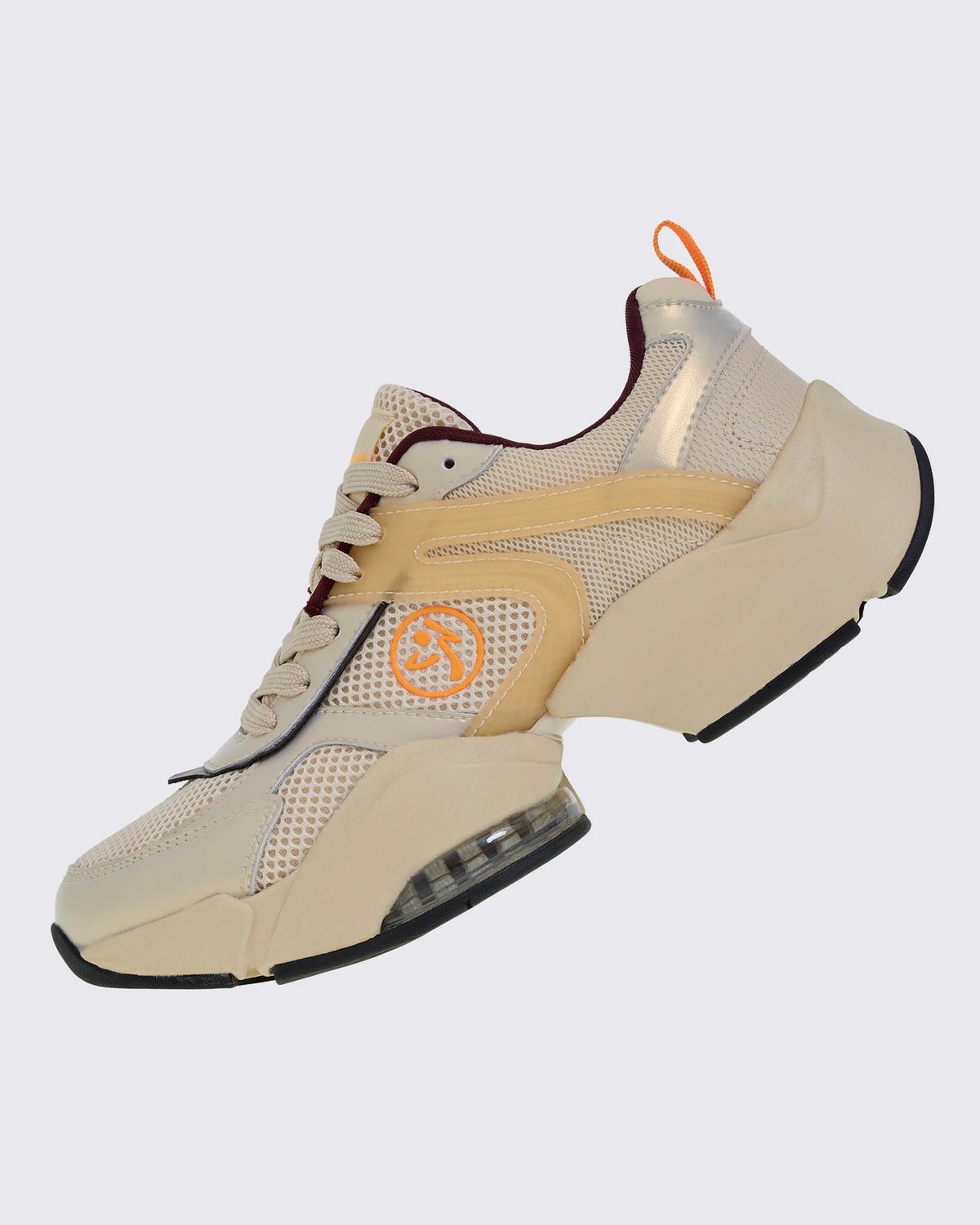Left side view of a beige platform shoe with an orange Zumbito logo, wavy translucent tan overlays, a metallic gold heel panel, and a chunky split sole with a black outsole.