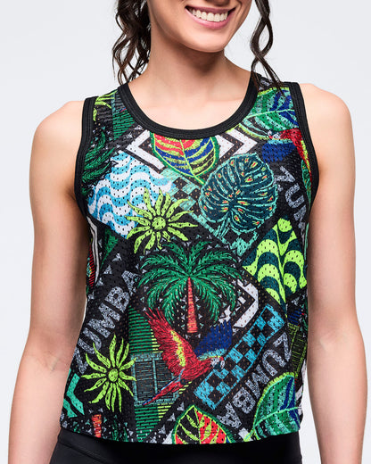 Close-up of the tropical-print sleeveless tank showing the multicolor jungle-inspired pattern and black neckline trim on a female model against a white background.