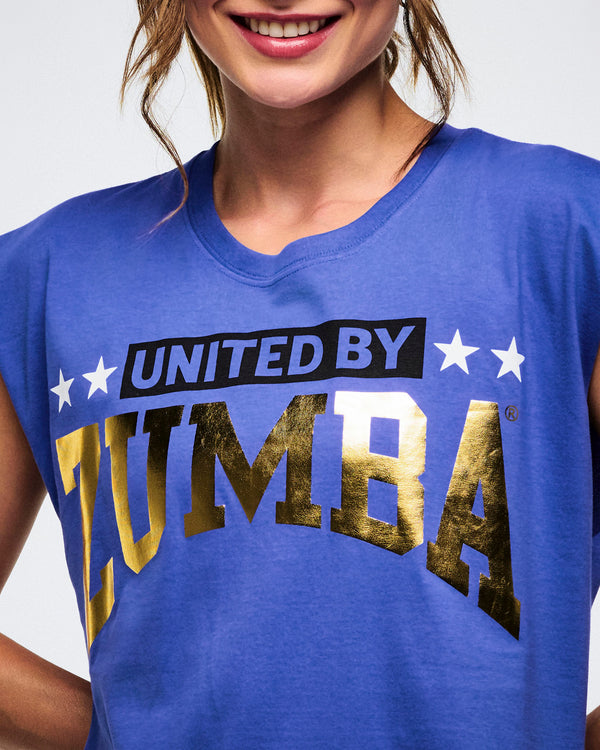 Close-up of a female model wearing a blue t-shirt with 'UNITED BY ZUMBA' text.