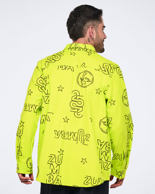 Neon green long-sleeve button-down shirt with black allover Zumba logo print. Male model wears the relaxed collared shirt with black pants, shown from the back against a light gray background.