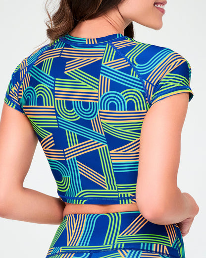 Shown from the back, the blue retro striped-letter crop top, with short cap sleeves and a cropped hem above matching print biker shorts.