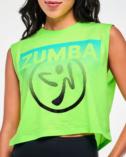 Close-up of white "ZUMBA" text on a aqua patch and a black dot pattern Zumbito logo on a neon green cropped tank.