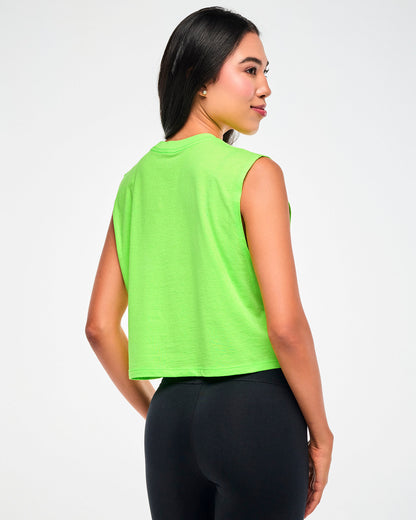 Female model wearing a neon green cropped tank, shown from the back, paired with black leggings.