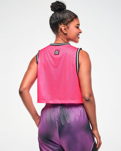 Shown from the back, female model wearing a pink mesh tank, with the cassette tape tag toward the top and pink and black dot pants.