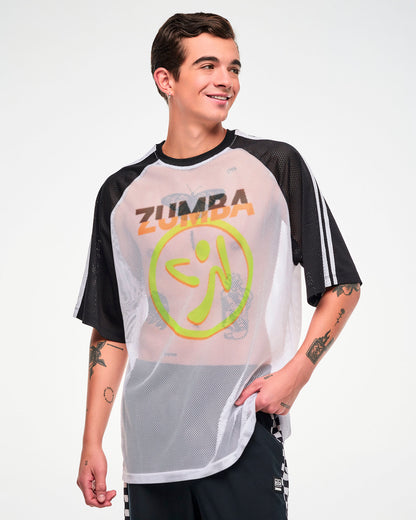 Male model wearing a white mesh oversized tee with black and white striped sleeves, a big yellow and orange Zumbito logo and "ZUMBA" text in black and orange above it, paired with black pants.