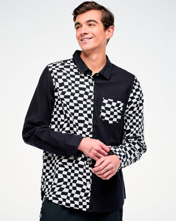 Close-up of a black and white checkered flannel button-up with a chest pocket on a male model.