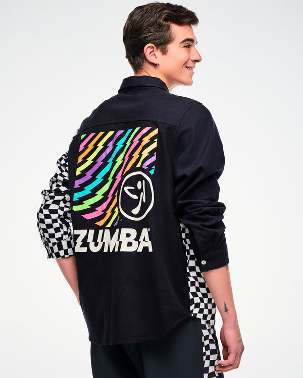 Shown from the back, male model wearing a black flannel button-up with a checkered sleeve and a rainbow lightning bolt 
