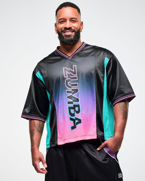 Close-up of a male model wearing an oversized black jersey tee with an aqua side panel and pink-to-purple gradient 
