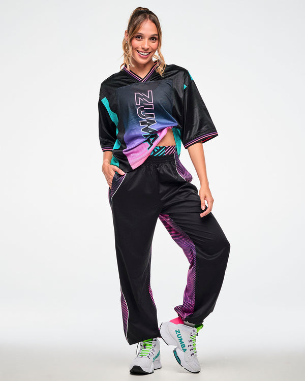 Female model wearing a black jersey tee with a pink-to-purple gradient 