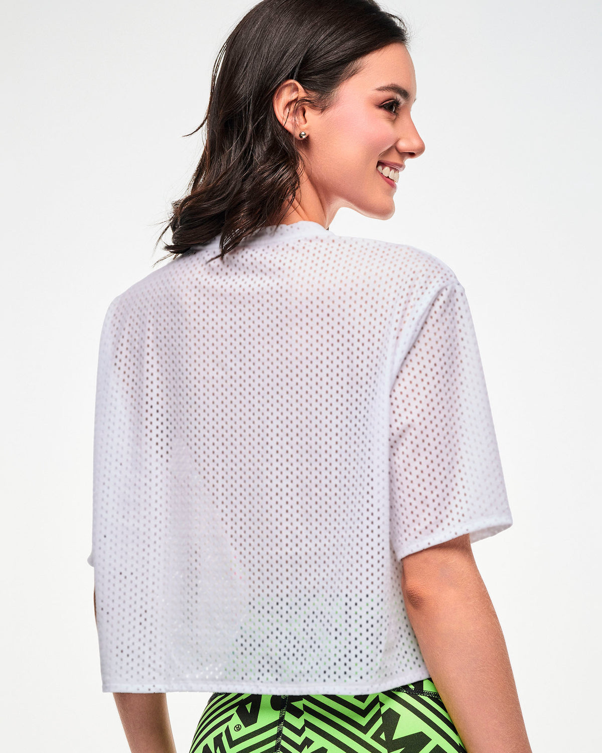 Back view of a female model wearing a white mesh crop top.