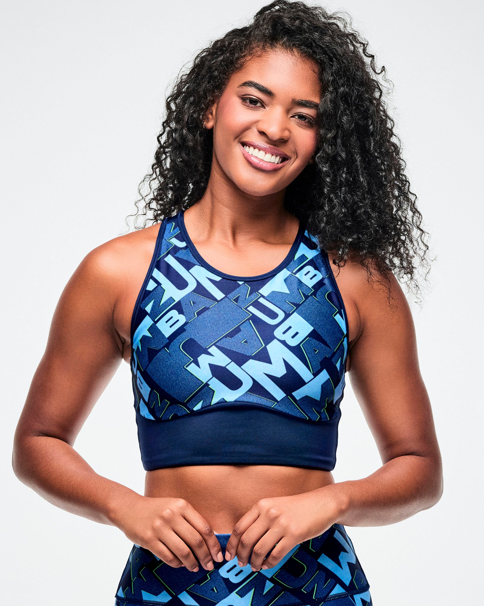 Female model wearing a blue patterned sports bra and leggings.