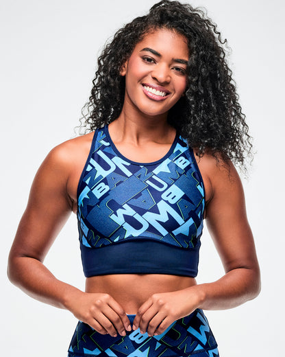 Female model wearing a blue patterned sports bra and leggings.