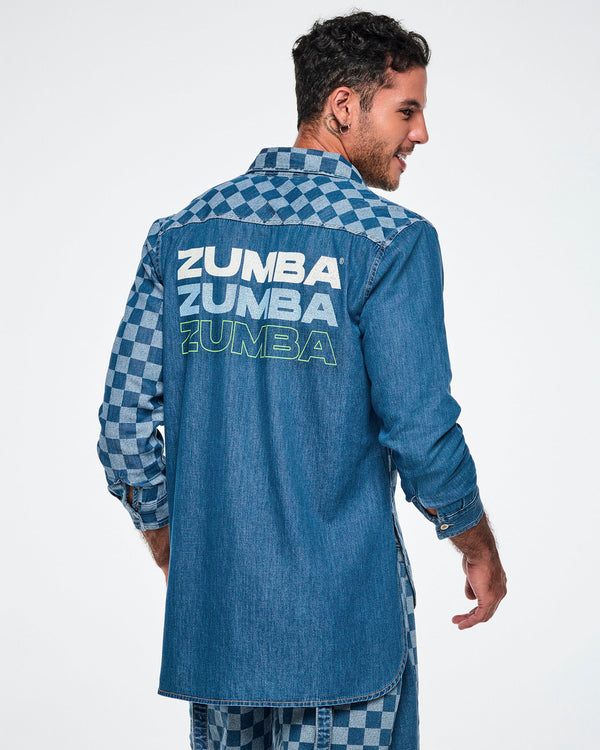 Back view of a male model wearing a denim button-down with a longer back hem and a checkerboard left sleeve, featuring 