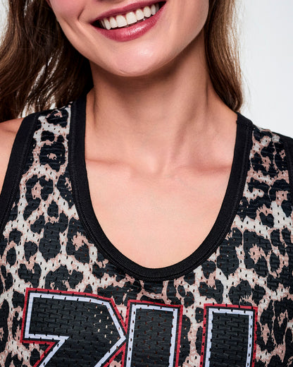 Close-up of a female model wearing a basketball tank top with a black leopard print pattern and a black scoop neckline.