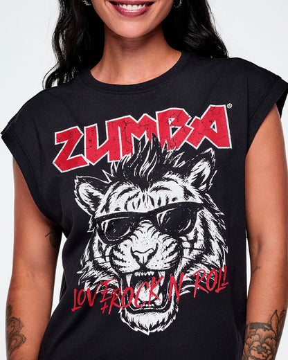 Close-up of a female model wearing a black tank featuring a large black and white tiger graphic with sunglasses, red 'ZUMBA' text at the top, and red 'LOVE + ROCK 'N' ROLL' text at the bottom.