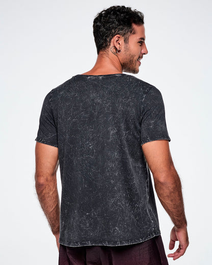 Back view of a male model wearing a black acid-washed patterned Zumba graphic tee, paired with gradient red and black pants.