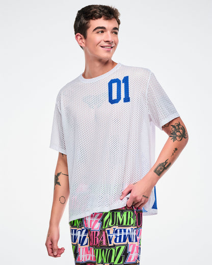 Male model wearing a white mesh top with a blue number '01' and colorful pants on a white background.